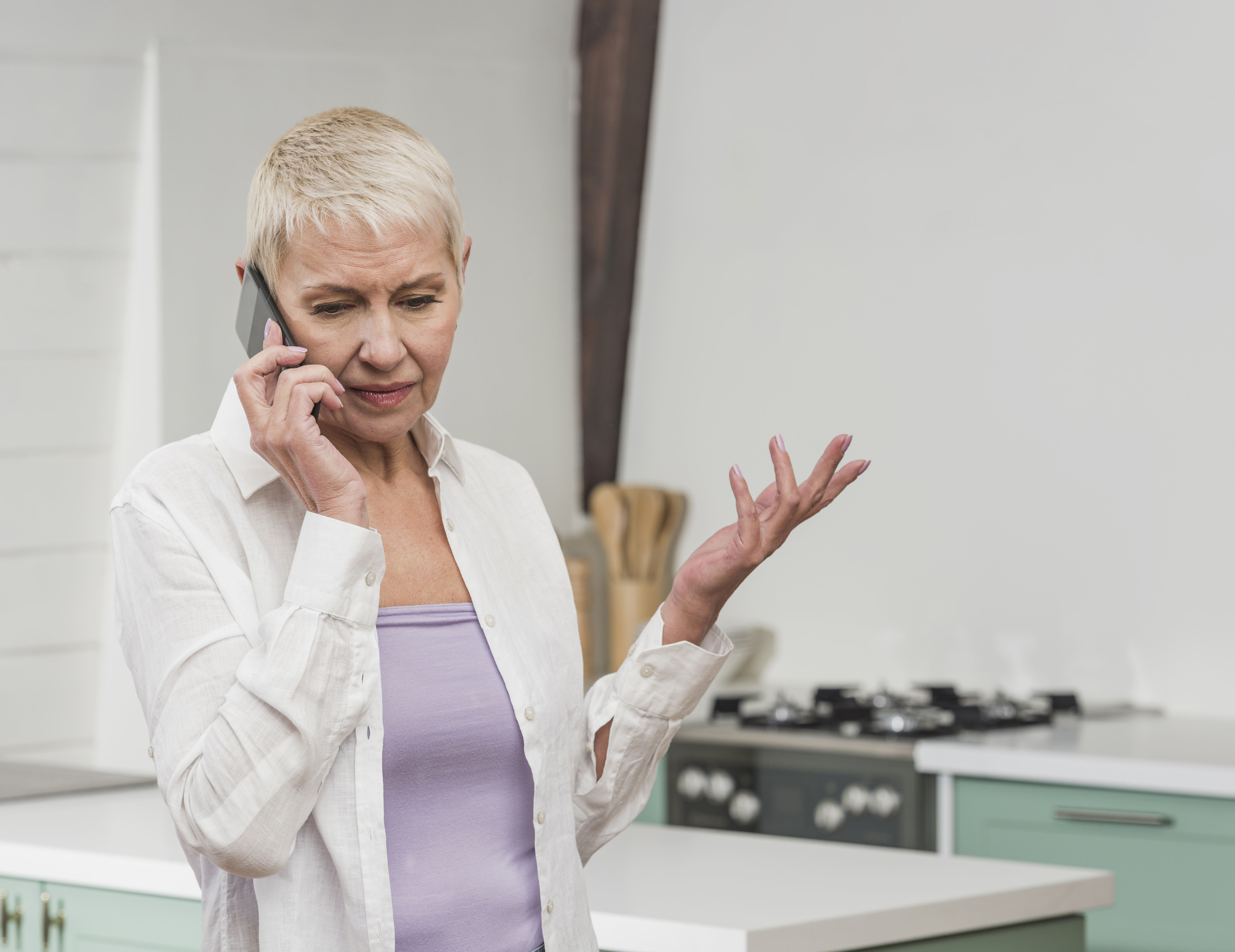 An older woman on a phone call | Source: Freepik