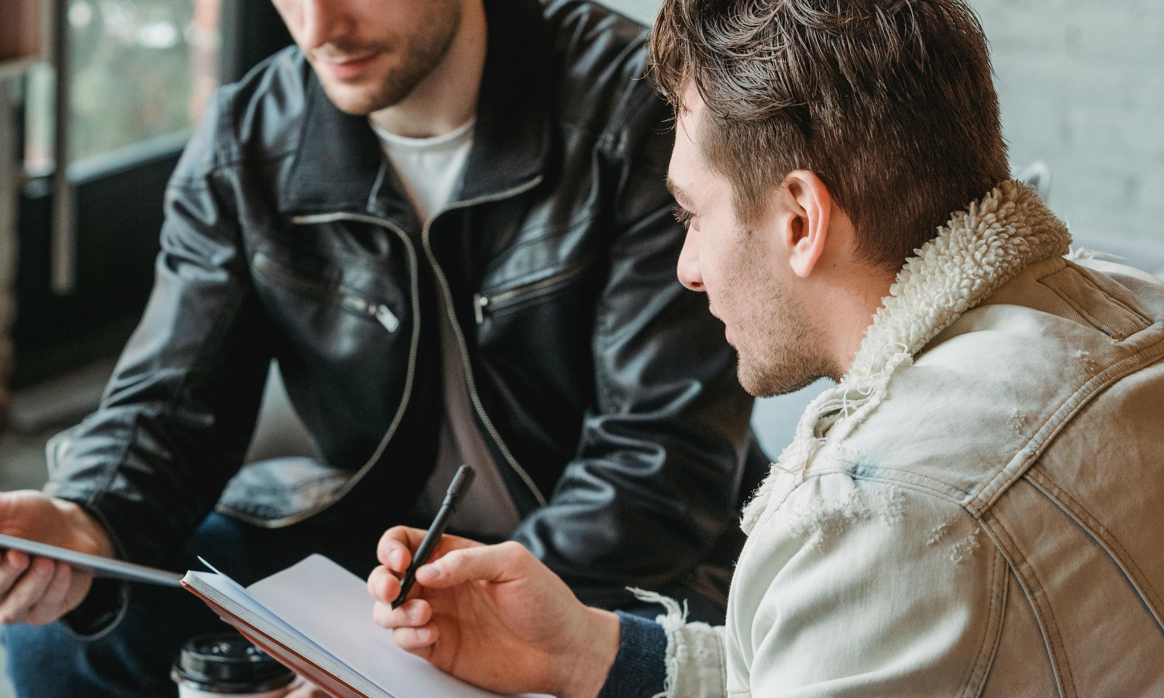 The team sign the final papers for the coffee shop the next day | Source: Pexels