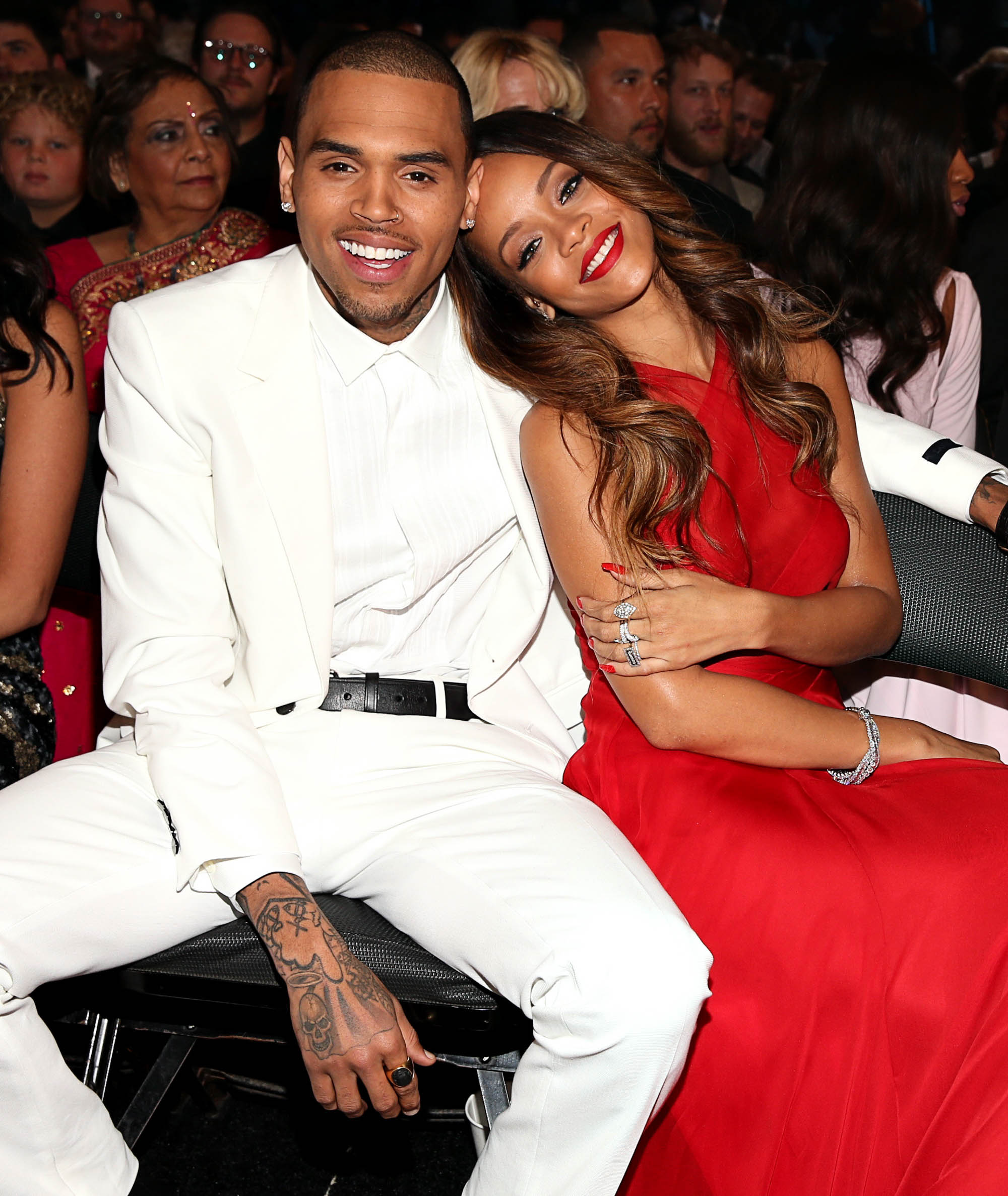 Rihanna and Chris Brown sitting together at an awards show.