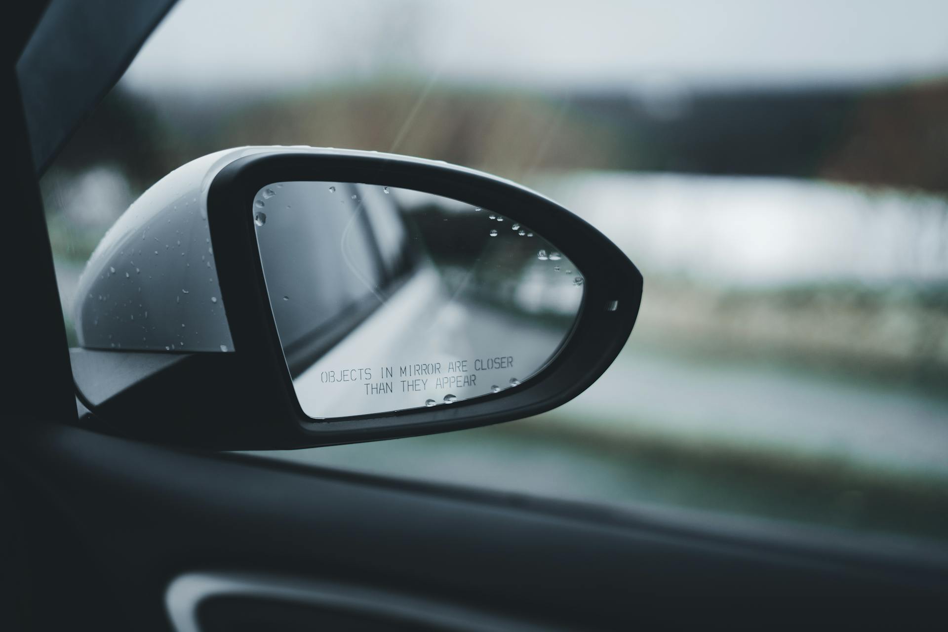 A closeup shot of a car's side view mirror in the rain | Source: Pexels