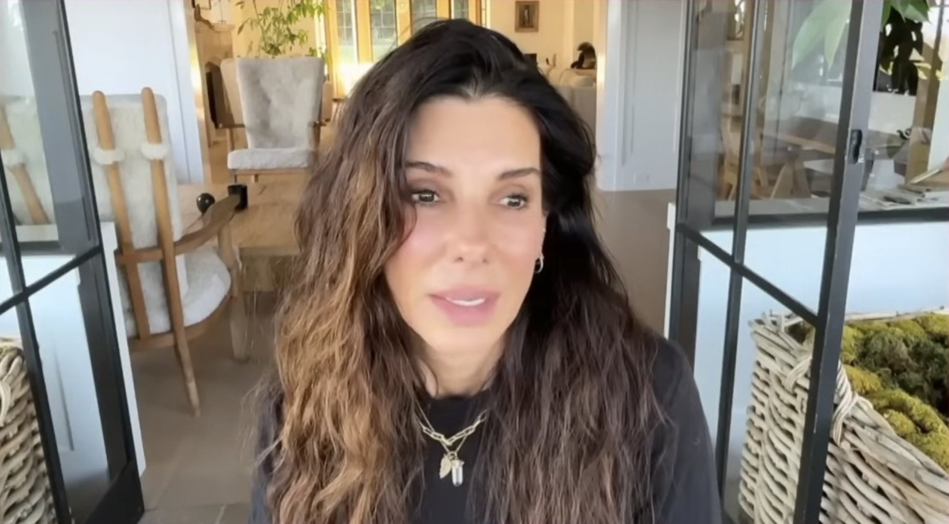 A screenshot of Sandra Bullock speaking in a video posted on August Aug 12, 2024 | Source: YouTube/@HodaAndJenna