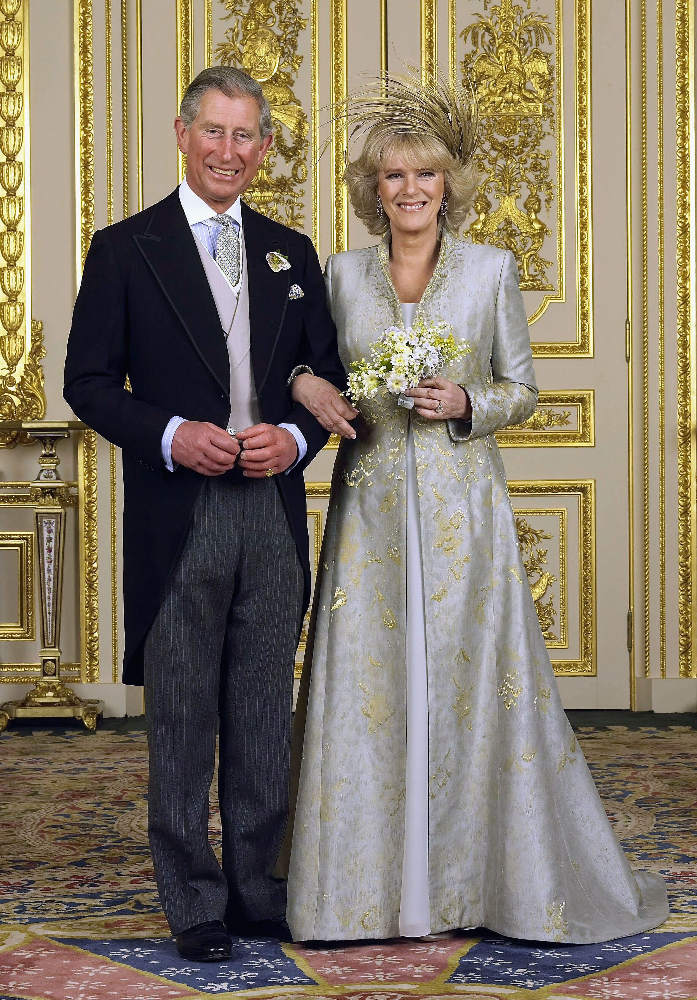 Prince Charles and The Duchess of Cornwall, Camilla Parker Bowles pose in the white drawing room for the Official Wedding group photo following their earlier marriage in Berkshire, England, on April 9, 2005 | Source: Getty Images