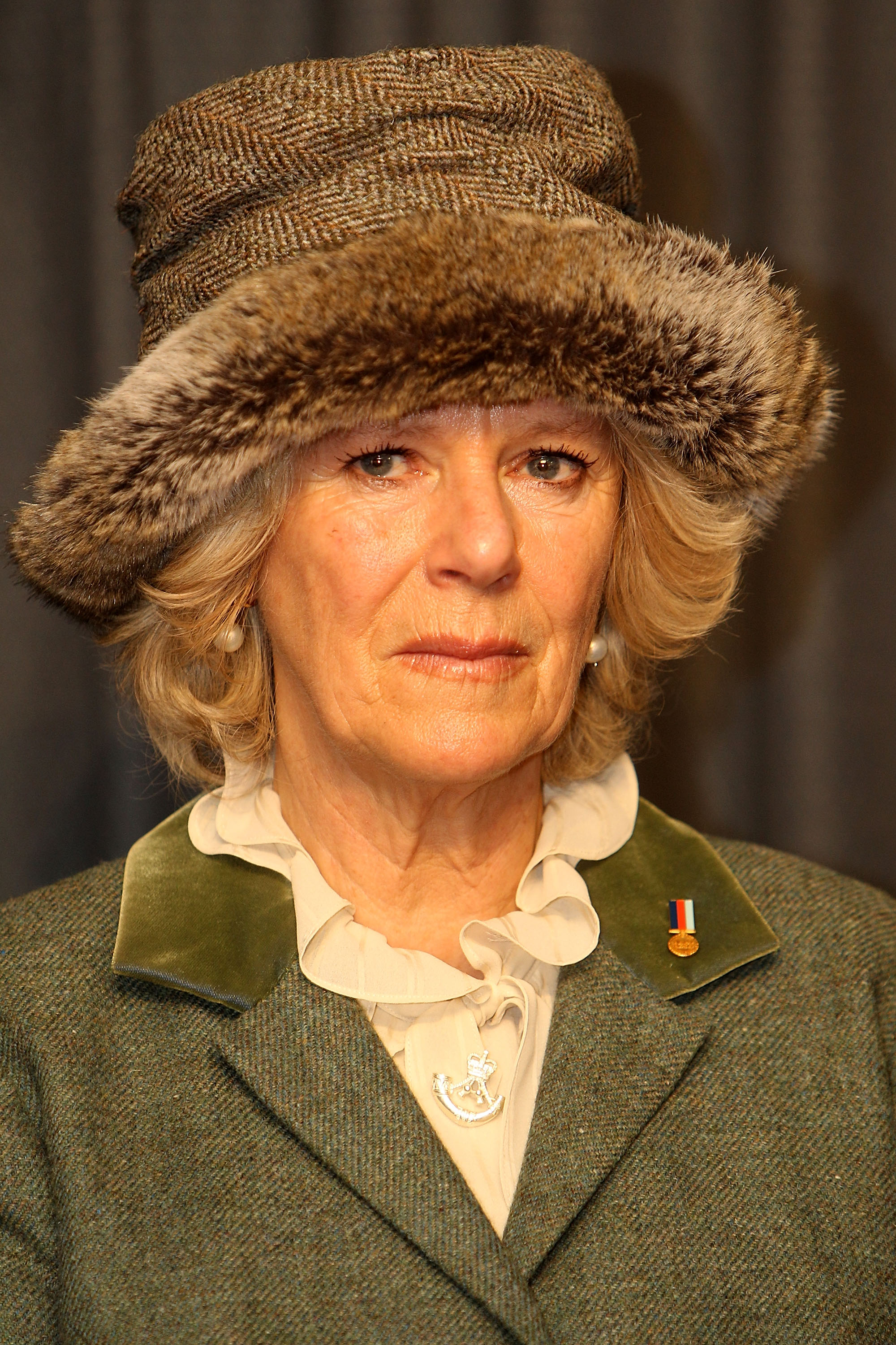 Camilla, Duchess of Cornwall wears a Help for Heroes badge and also motif of The Rifles during her visit to Wootton Bassett, England, on January 29, 2010 | Source: Getty Images