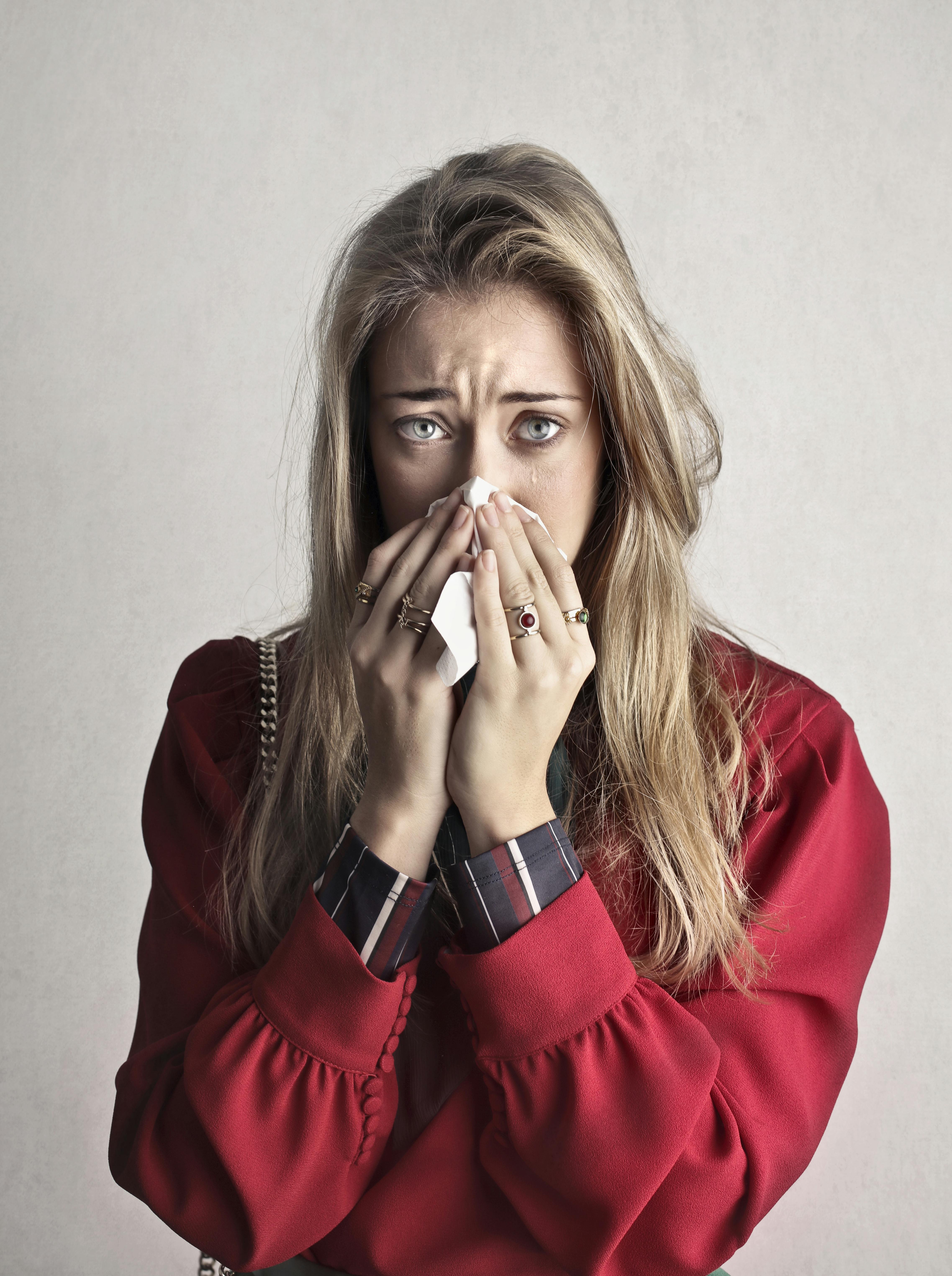 A teary-eyed woman covering her mouth | Source: Pexels