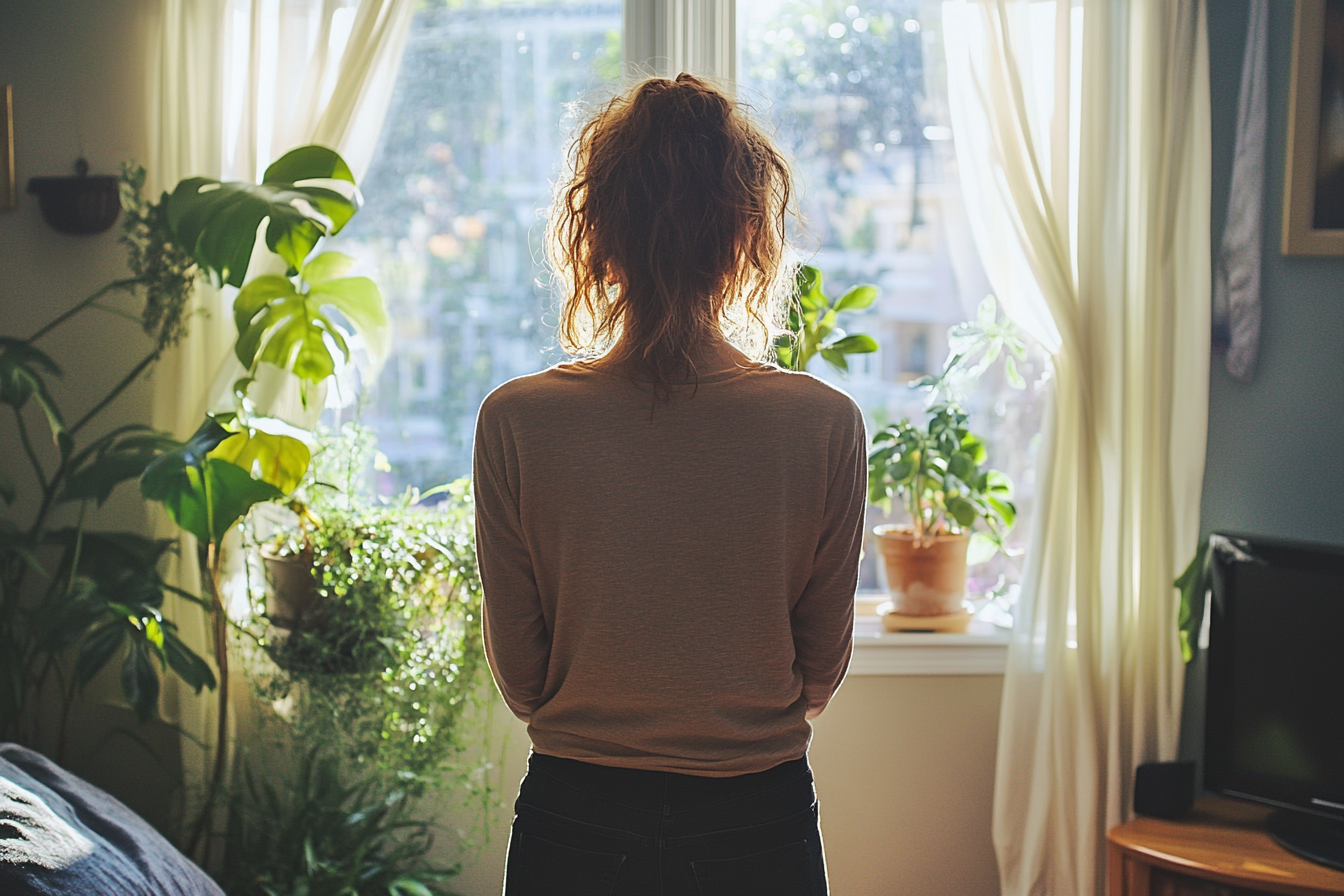 A woman standing in her living room | Source: Midjourney