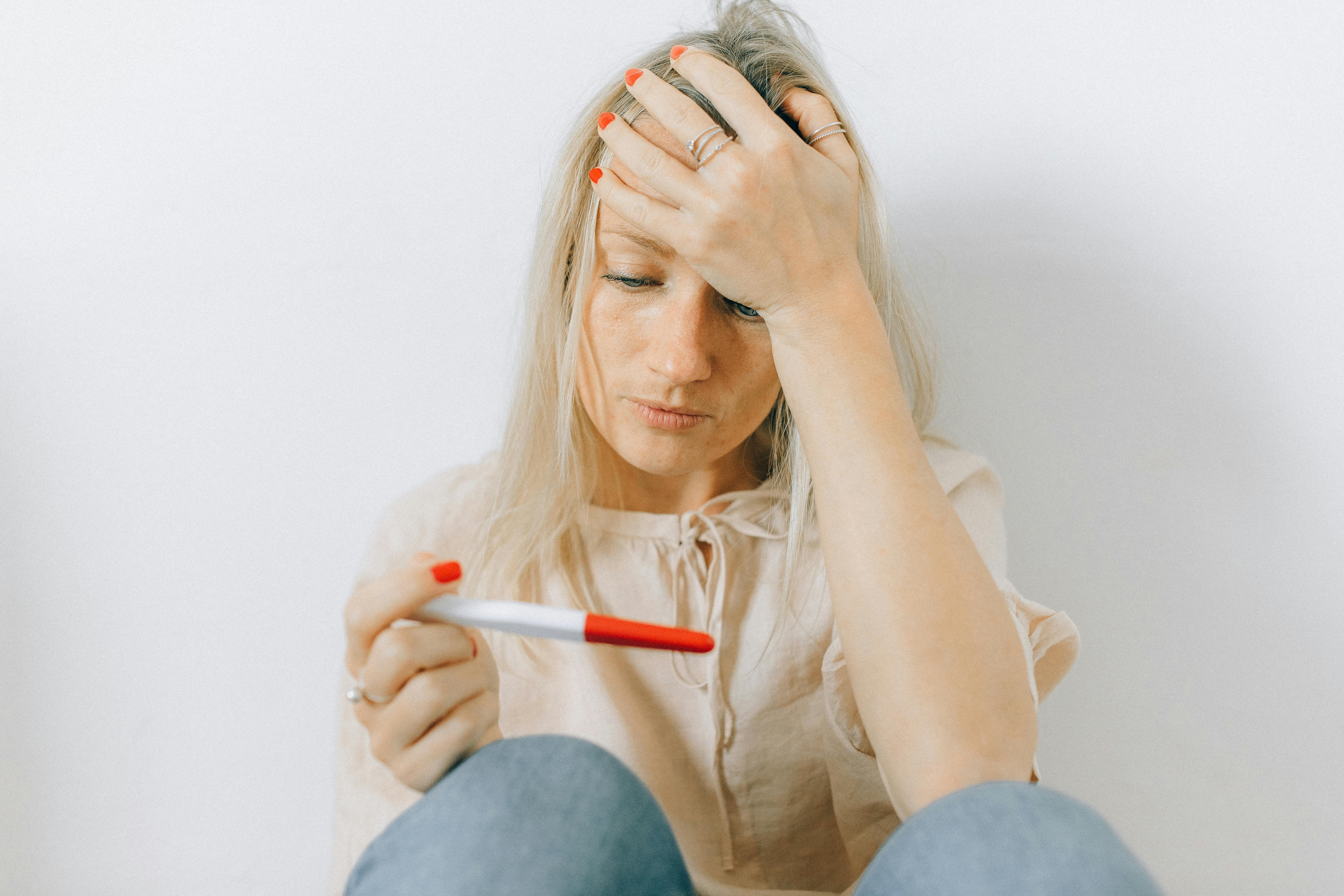 A worried woman looking at her pregnancy result | Source: Pexels