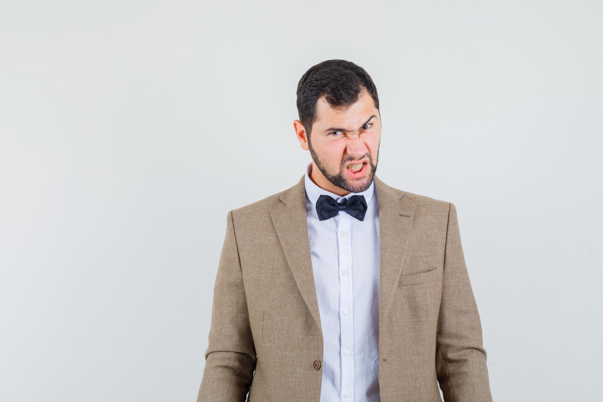 An angry man in a suit | Source: Freepik