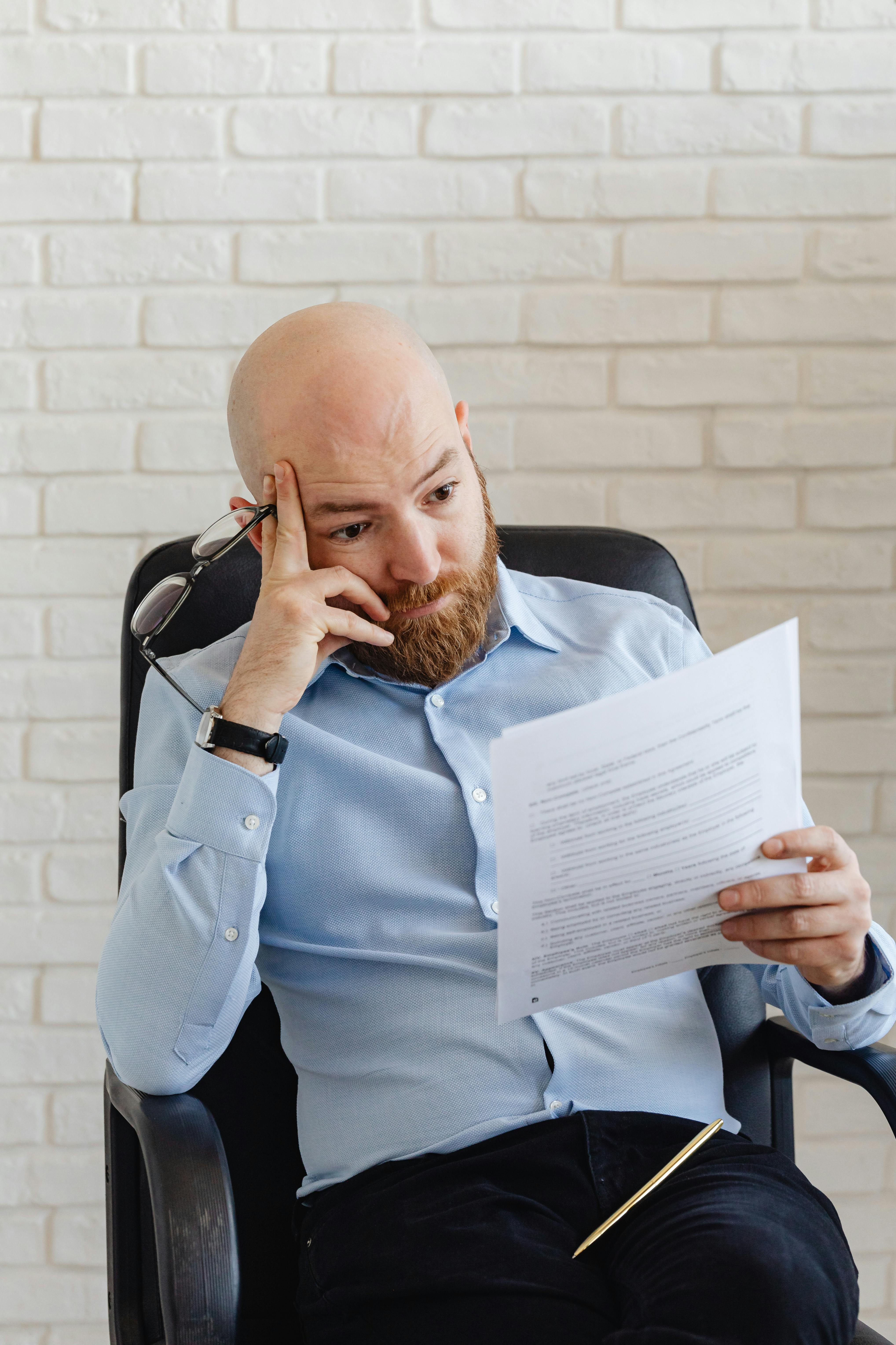 A man looking at receipts | Source: Pexels