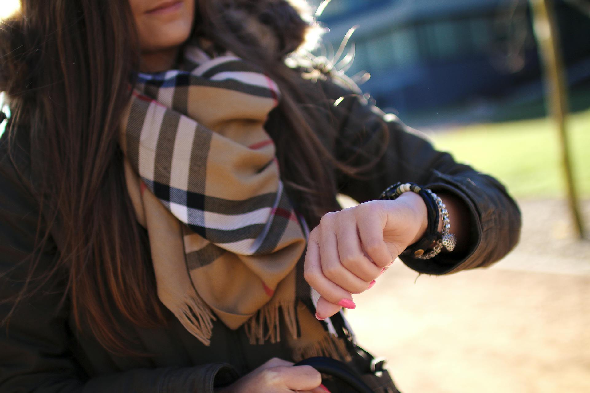 A woman checking the time on her watch | Source: Pexels