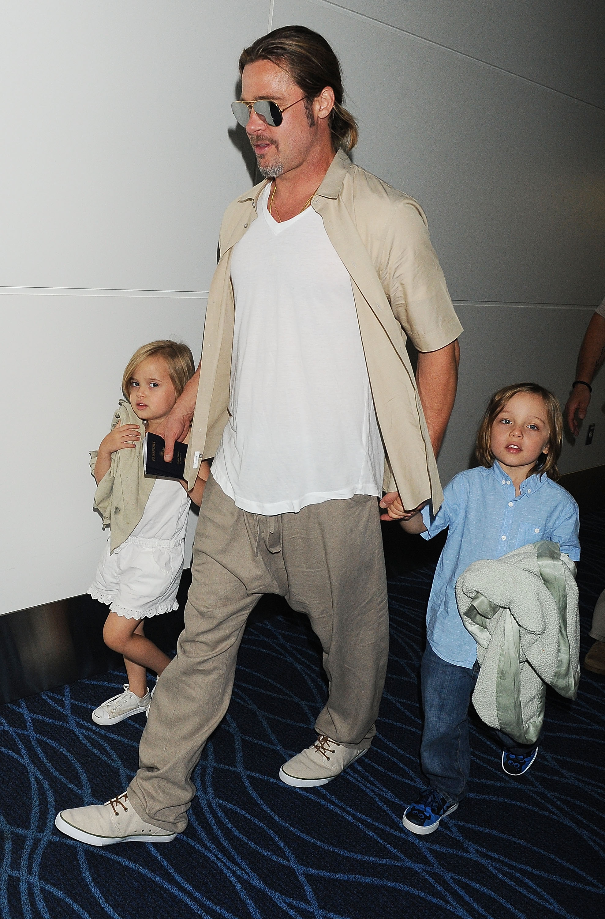 Brad Pitt, Knox Jolie-Pitt, and Vivienne Jolie-Pitt seen in Tokyo, Japan, on July 30, 2013 | Source: Getty Images