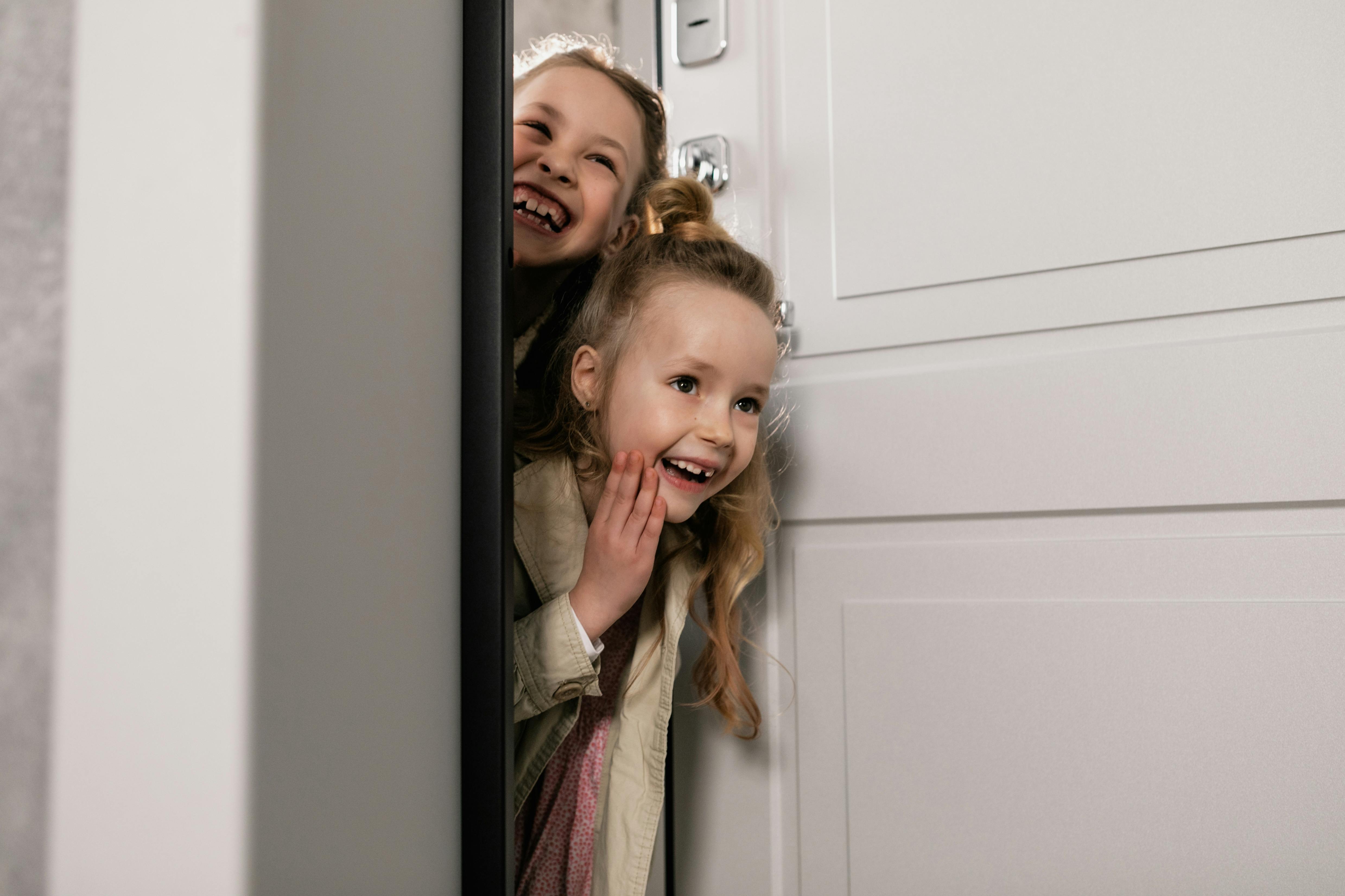 Two girls standing by the door | Source: Pexels