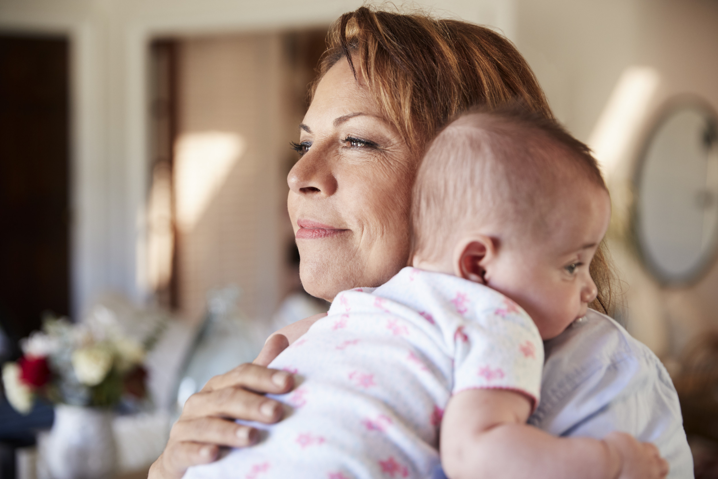 Middle Aged Woman Holds Baby