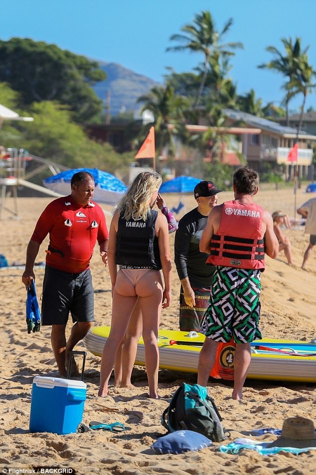 Getting instructions: The Parent Trap actor and his statuesque love, 31, were seen sharing kisses on the beach before suiting up in life jackets for water sports, including SUPswatching