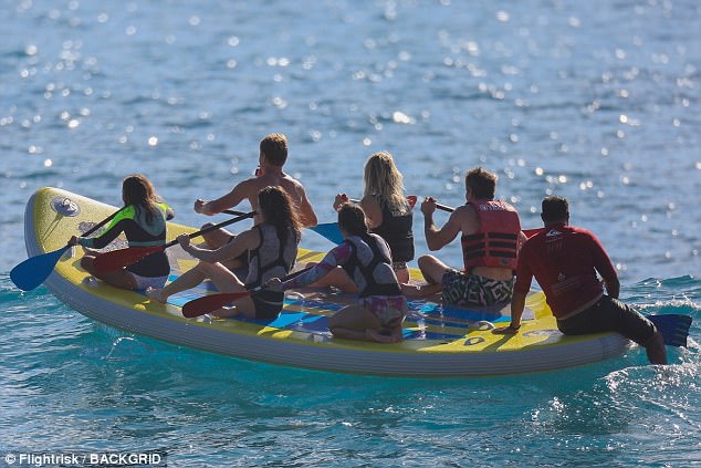 Here they go: SUPsquatching is an activity that involves paddle boarding as a group on a inflatable board