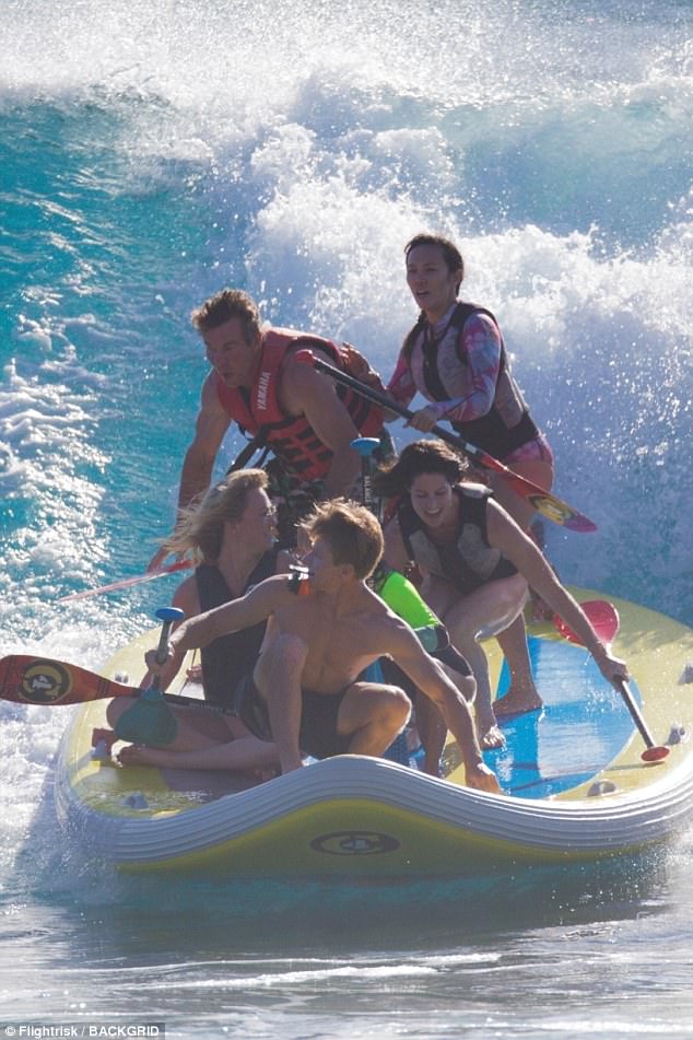 Looks fun: The Parent Trap actor and his statuesque love, 31, were seen sharing kisses on the beach before suiting up in life jackets for some water sport activities, including SIPsquatching