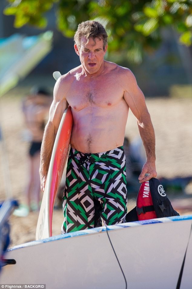 Wow: The star carried a board and his life jacket while showing off his toned form