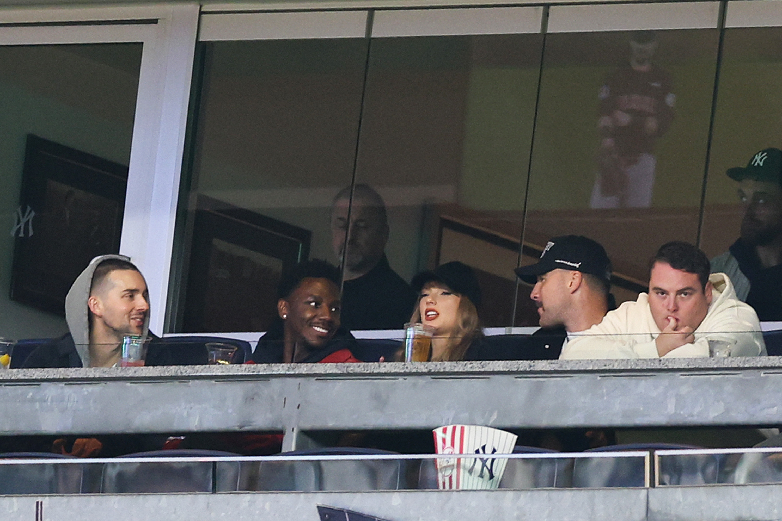 Jerrod Carmichael, Taylor Swift and Travis Kelce attend Game One of the American League Championship Series at Yankee Stadium on October 14, 2024, in New York City | Source: Getty Images