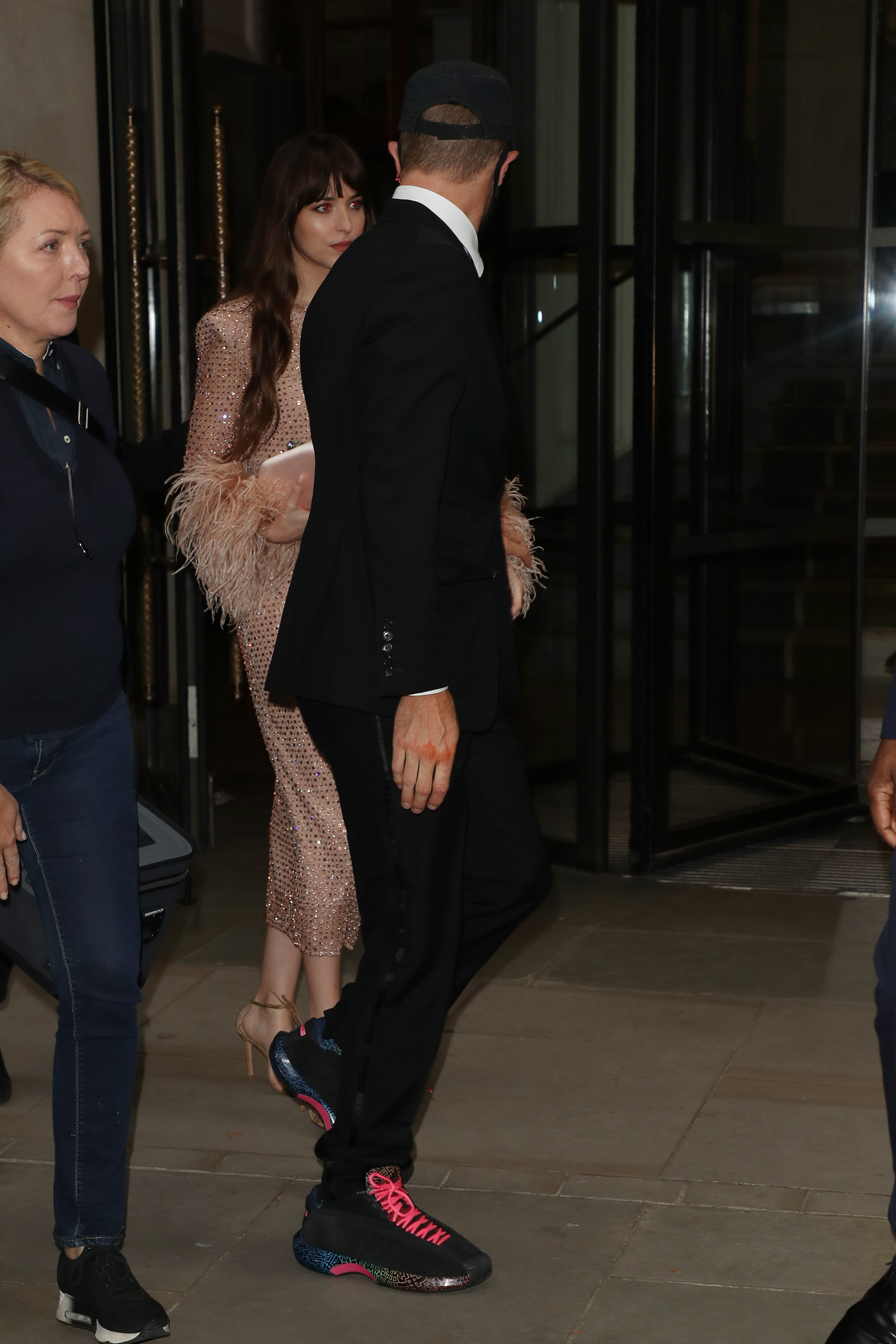 Chris Martin and Dakota Johnson seen leaving The Corinthia Hotel ahead of the "The Lost Daughter" UK Premiere on October 13, 2021, in London, England | Source: Getty Images