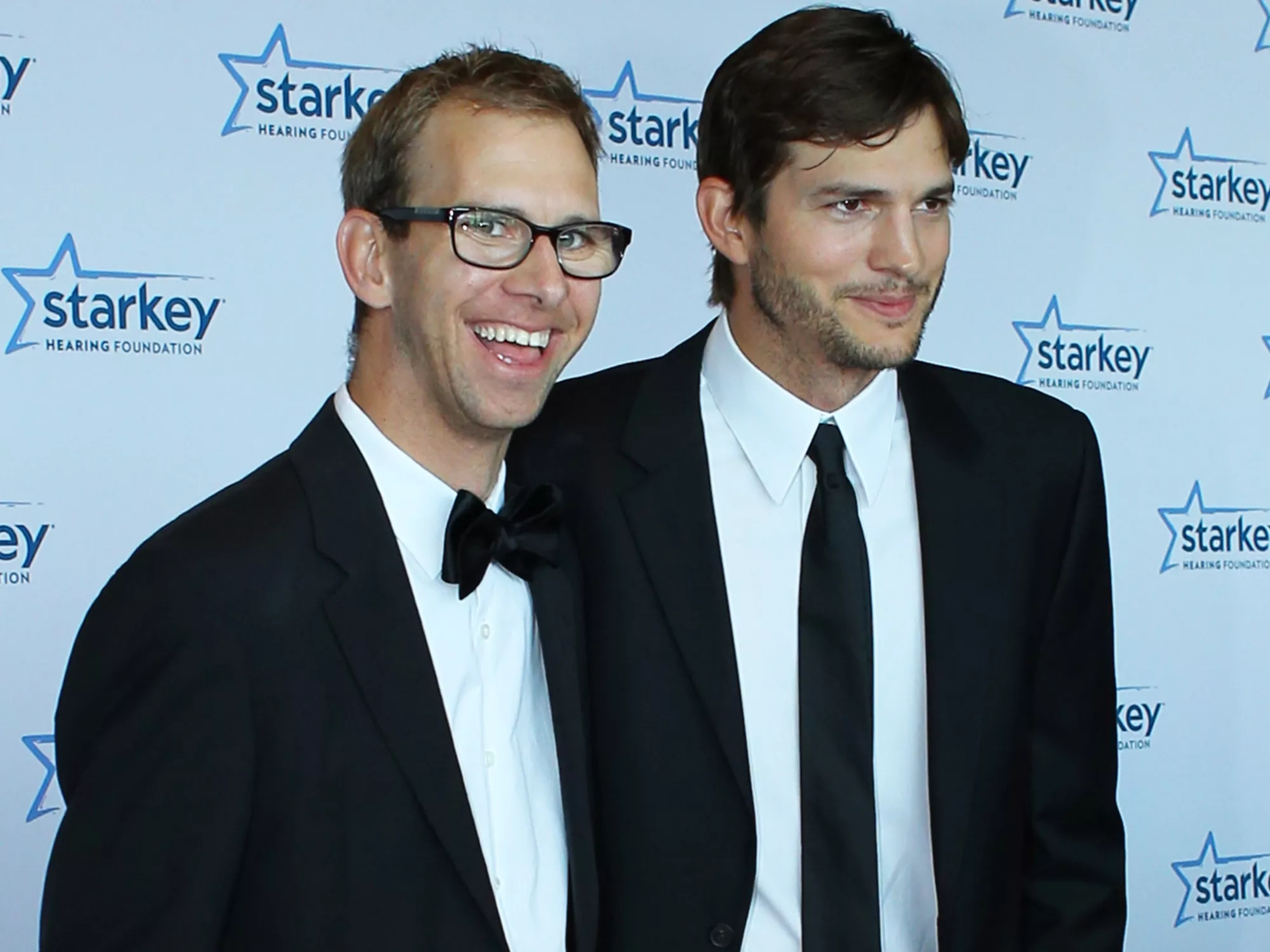 Michael Kutcher and brother Ashton Kutcher walk the red carpet before the 2013 Starkey Hearing Foundation's 