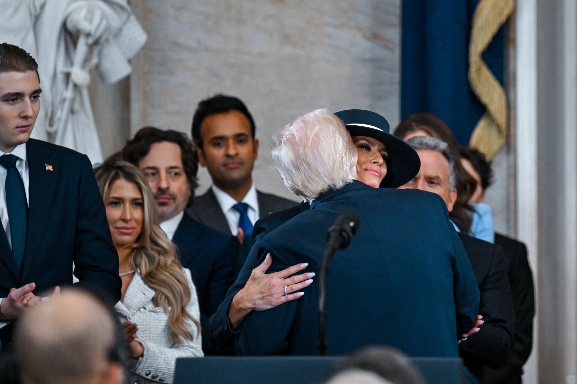 President Donald Trump embraces first lady Melania Trump after being sworn in during his inauguration in the U.S. Capitol Rotunda on January 20, 2025 | Source: Getty Images