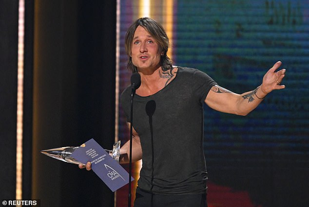Tearing up: The John Cougar, John Deere, John 3:16 singer was named Entertainer of the Year, the night's biggest awards