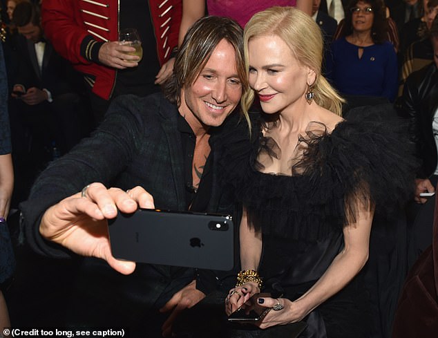 Happy couple: The statuesque 51-year-old Australian actress couldn't wipe the proud smile from her face as the 51-year-old country star took home his award
